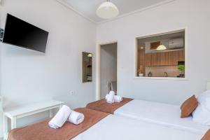 a bedroom with two beds and a flat screen tv at Silia apartments 3 in Ampavris