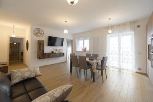 a living room and dining room with a table and chairs at La MaGia del Tramonto in Salerno