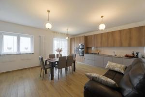 a living room and kitchen with a table and chairs at La MaGia del Tramonto in Salerno