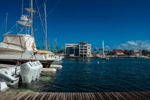 a group of boats docked at a dock in the water at Le Lagon Vert in Saint-François