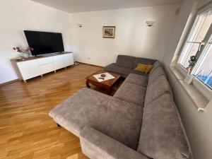 a living room with a couch and a television at Apartman Surya Medulin in Medulin