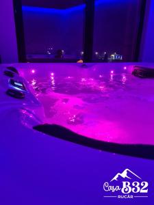 a hot pink bathtub with pink lights in a room at Casa B32 Spa Rucar in Rucăr +37 photos