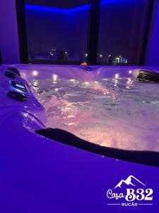 a jacuzzi tub in a room at night at Casa B32 Spa Rucar in Rucăr