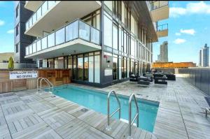 a building with a swimming pool in front of a building at Luxurious Downtown condo with spectacular views in Calgary