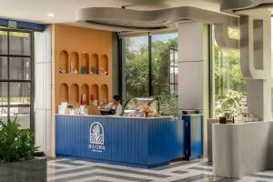 a restaurant with a blue counter in a building at Seabed Grand Hotel Phuket in Phuket