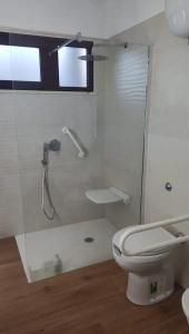 a white bathroom with a toilet and a shower at Holiday Rooms in Santa Teresa in Santa Teresa Gallura