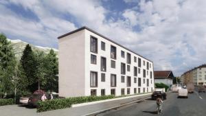 a white building on the side of a street at myQuartier Urban Residences digital self check in in Innsbruck