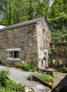 an old stone house with a garden in front of it at Ostalon de Sénégats in Lacaze