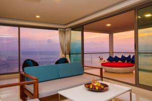 a living room with a view of the ocean at Oh La La Koh Phangan in Haad Rin