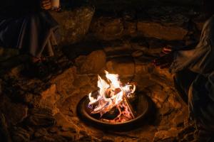 a fire in a stone oven with flames at 本格貸切サウナの宿 つづやビレッジ in Minokamo +34 photos