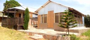 a house with a tree in front of it at RetoSafarisMara in Masai Mara