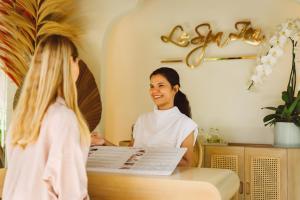 a woman sitting at a table in a hair salon at Zazen Boutique Resort & Spa in Bophut +37 photos