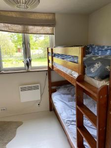 a room with two bunk beds and a window at JES Kalana Beachhouse in Kalana