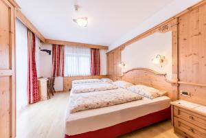 Postel nebo postele na pokoji v ubytování Garni Hotel Residence Diamant