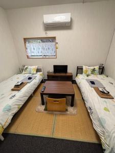 Postel nebo postele na pokoji v ubytování Hostel John Mang ゲストハウス ジョン