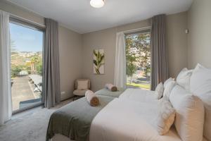 a bedroom with a large bed and a large window at OurMadeira - Palace Ocean View in Funchal +24 photos