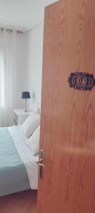 an open door to a bedroom with a bed at Casa Filo - Country house near la Cruz de Piedra in Plasenzuela