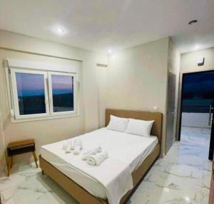 a bedroom with a bed with towels on it at Villa Athina 1 in Serres