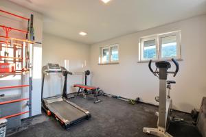 a gym with two tread machines in a room at Apartament Szczęśliwy in Ustrzyki Dolne