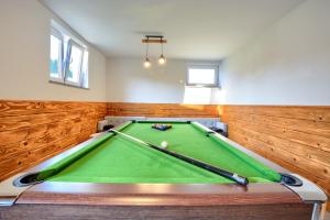 a pool table in a room with wood paneling at Apartament Szczęśliwy in Ustrzyki Dolne +9 photos
