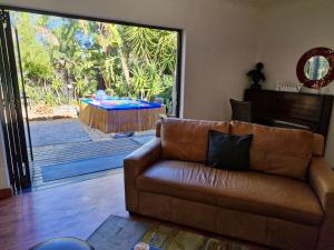a living room with a couch and a large sliding glass door at Regent Casa's - Cape Towns Blouberg Area - Where 20 people can stay in Cape Town