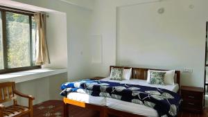 Postel nebo postele na pokoji v ubytování Shiv Shakti Yogpeeth Cottages
