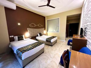Postel nebo postele na pokoji v ubytování Aryana Queen Beach Resort