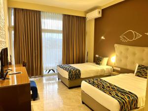 Postel nebo postele na pokoji v ubytování Aryana Queen Beach Resort