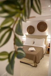 a bedroom with a bed and a plant at Oneiro 4BDR Villa in Antiparos Sirocco Villa in Andiparos