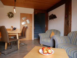 a living room with two couches and a table with a bowl of fruit at Haus Edelweiß in Bad Hindelang