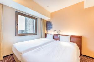 Postel nebo postele na pokoji v ubytování Hotel Keihan Asakusa