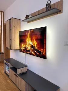 a fireplace in a living room with a fire in it at Tanasković Home Zlatibor in Zlatibor
