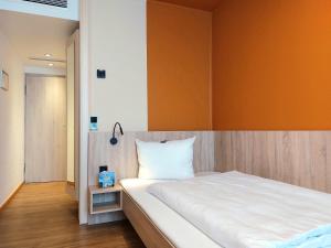 Postel nebo postele na pokoji v ubytování Heinrich Pesch Hotel