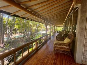 a porch with wicker chairs on a wooden deck at Large Private Villa, central Seminyak, Bali in Seminyak