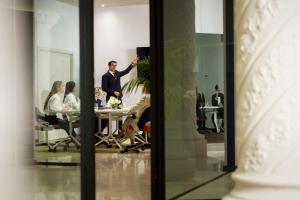 a man in a suit standing in front of a meeting room at NH Collection Buenos Aires Jousten in Buenos Aires