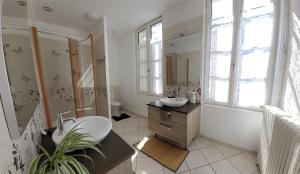 a bathroom with a sink and a toilet and a tub at La Belle Etoile in Saintes