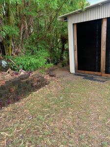 a garage with a bunch of bricks in the yard at Bushland View Retreat in Ocean Shores