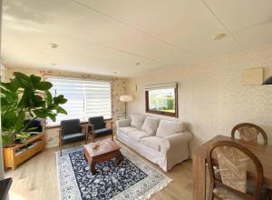 a living room with a couch and a table at Vakantiepark Callassande - CS 074 in Callantsoog