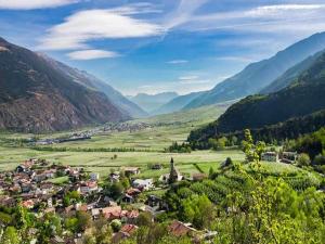 a small town in a valley in the mountains at Residence Lahnhof, Laces in Laces
