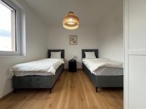 Posteľ alebo postele v izbe v ubytovaní Leopoldsdorf Premium Apartments