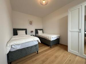 Posteľ alebo postele v izbe v ubytovaní Leopoldsdorf Premium Apartments