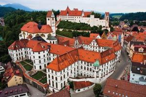 an aerial view of a town with white buildings at Hotel Fürstenhof in Füssen