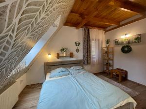 A bed or beds in a room at Csodaszarvas Vendégház