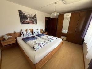 a bedroom with a large bed in a room at Panorama Apartments Semslach in Obervellach +35 photos