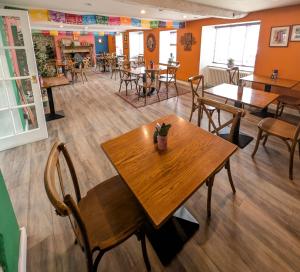 a restaurant with a wooden table and chairs at Northover Manor Hotel in Ilchester +36 photos