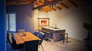 a dining room with a table and a fireplace at Villa Terrana near Rovinj for 6 people with private pool in Rovinjsko Selo