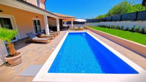 a swimming pool in the backyard of a house at Villa Terrana near Rovinj for 6 people with private pool in Rovinjsko Selo