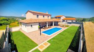 an aerial view of a house with a swimming pool at Villa Terrana near Rovinj for 6 people with private pool in Rovinjsko Selo +19 photos