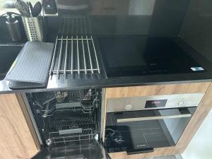 a dishwasher with its door open in a kitchen at T2 Mouguerre aux portes de Bayonne et Biarritz in Mouguerre +13 photos