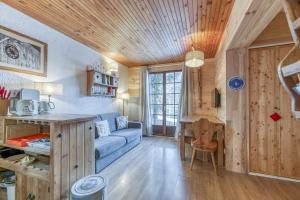 a living room with a blue couch and a table at Gawal 1 in Villard-Reculas